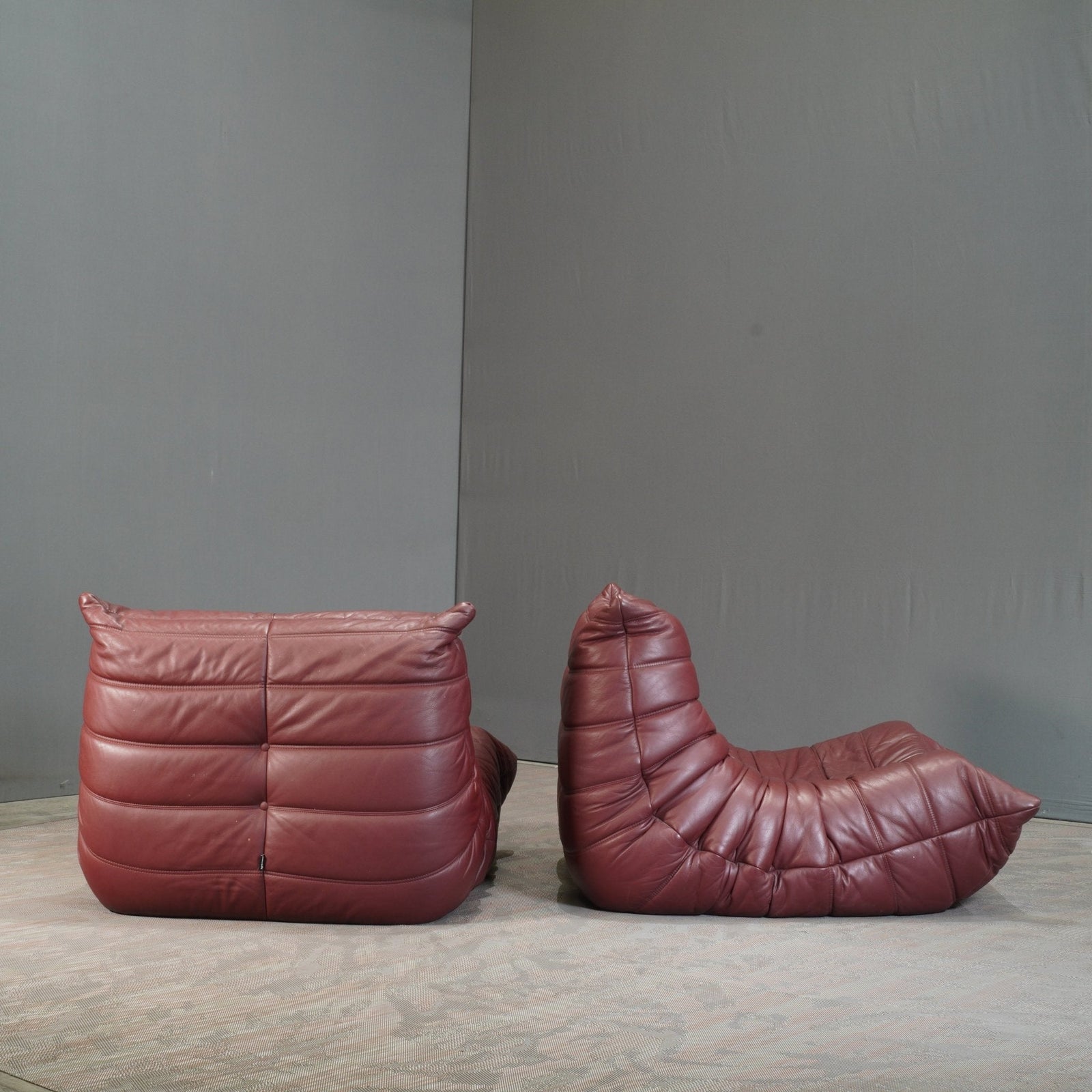 Ligne Roset Burgundy Leather Modular Sofas and Footstool, by Michel Ducaroy, Set of Six @ REHAUS